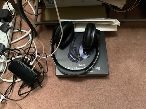 Black Oneodio headphones beside a home audio setup