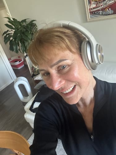 Customer wearing silver Oneodio headphones indoors