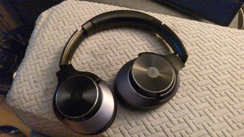 Black Oneodio headphones resting on a textured cushion