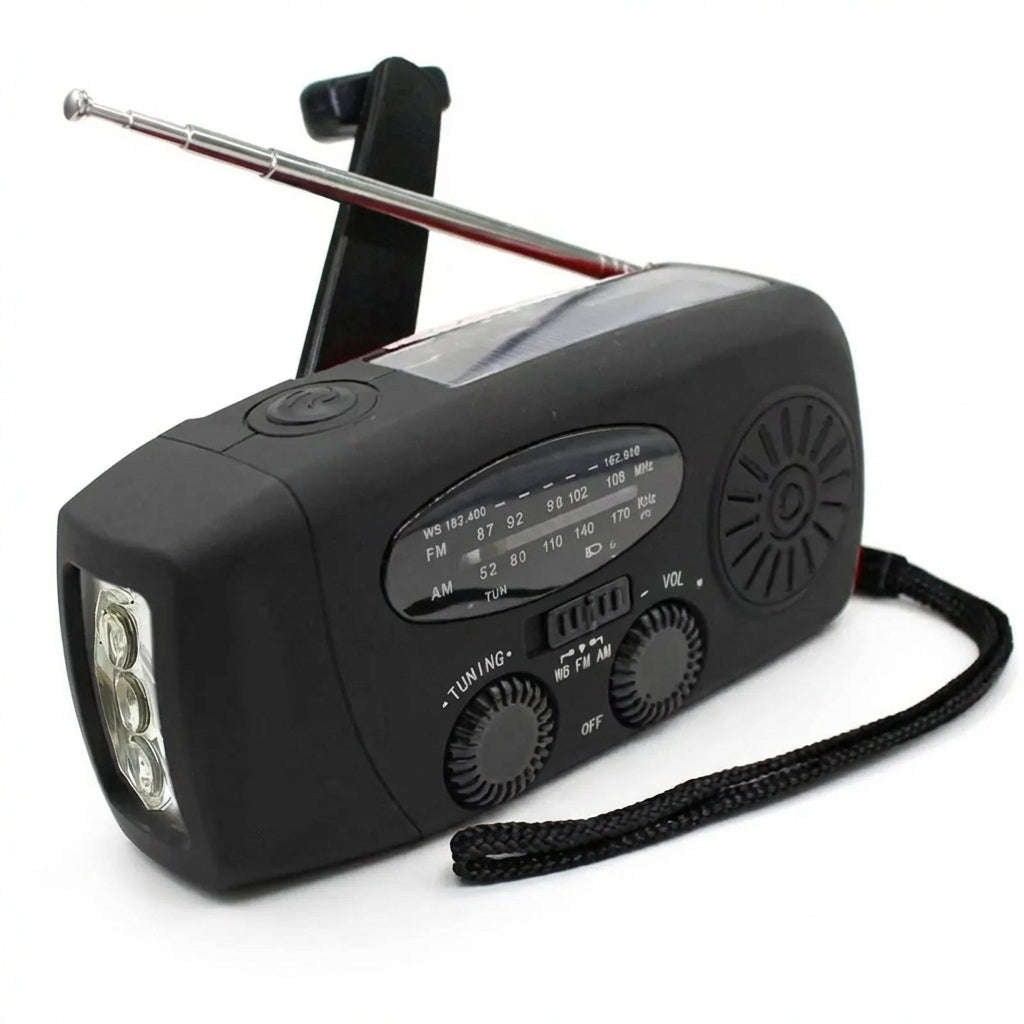 Black emergency radio showing the analogue tuner, speaker, band selector and front dials